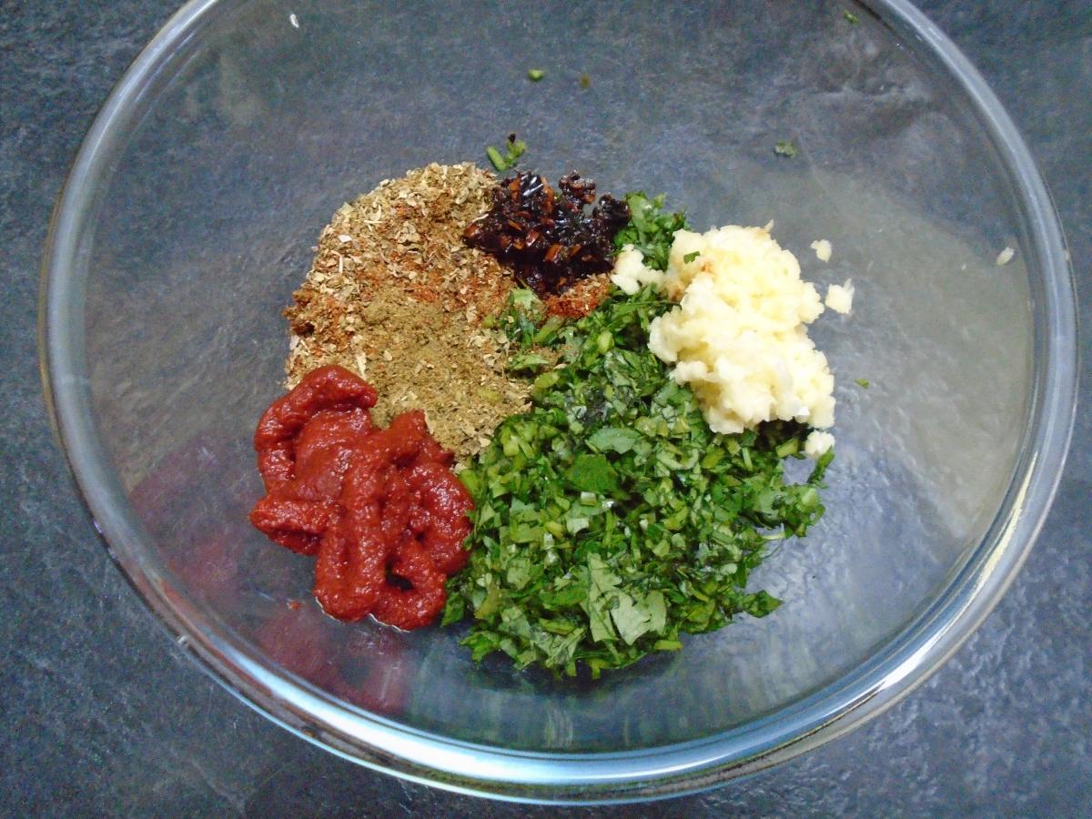 Finely chop 20g coriander & 1 dried chipotle then add 3 cloves crushed garlic, ½ tbsp tomato paste, ½ tsp oregano, 1 tsp chilli powder & ½ tbsp cumin