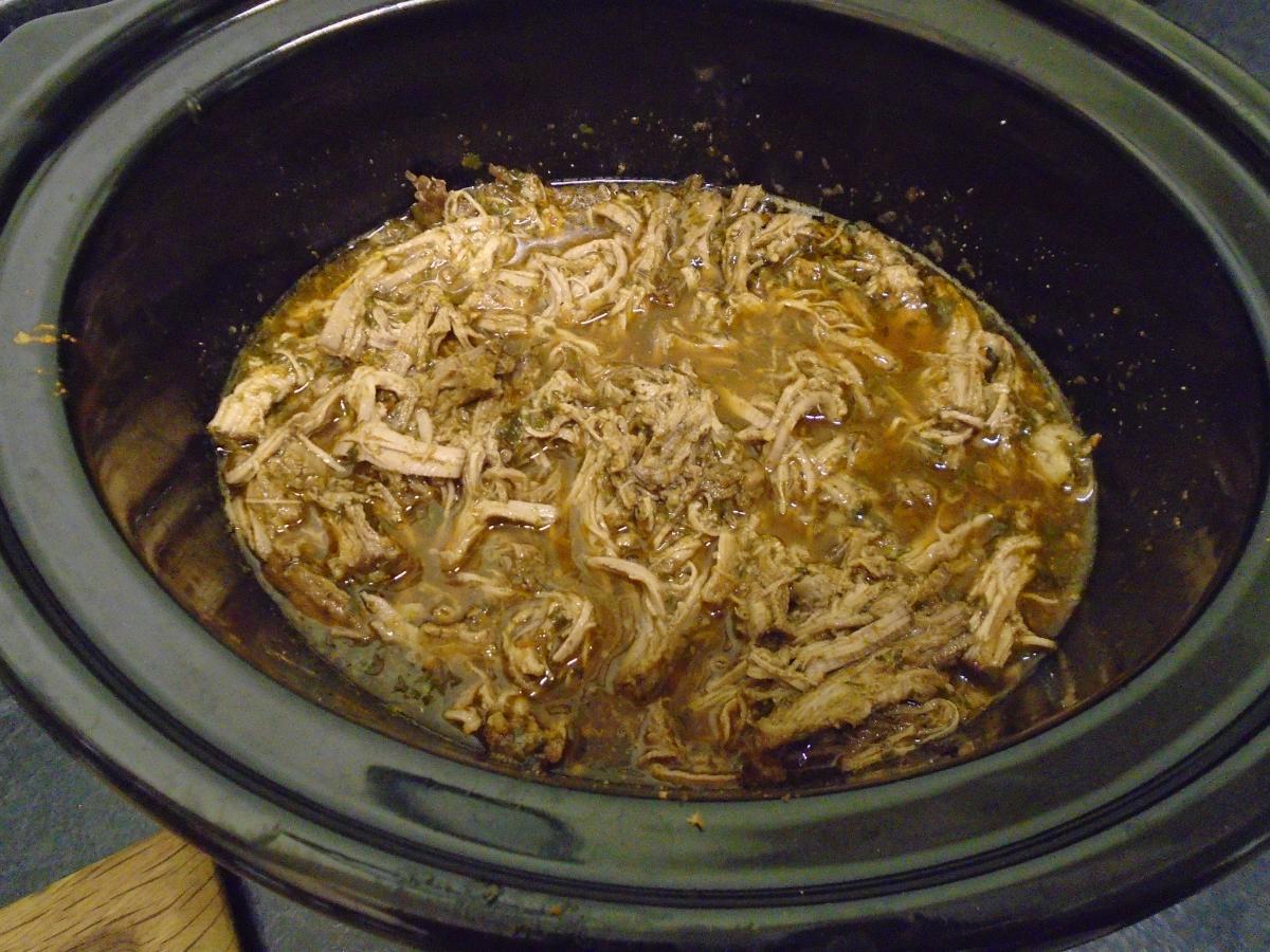 Return the shredded meat to the slow cooker on warm and leave it to soak in the liquid