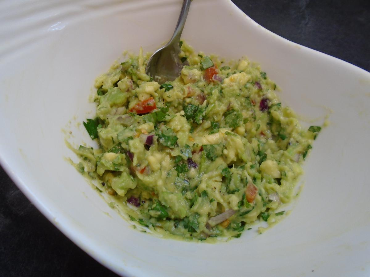 Make the guacamole by chopping 20g red onion, 25g tomatoes & 20g coriander and mixing with 150g mashed avocado flesh, the juice of 1 lime & 1 tsp olive oil
