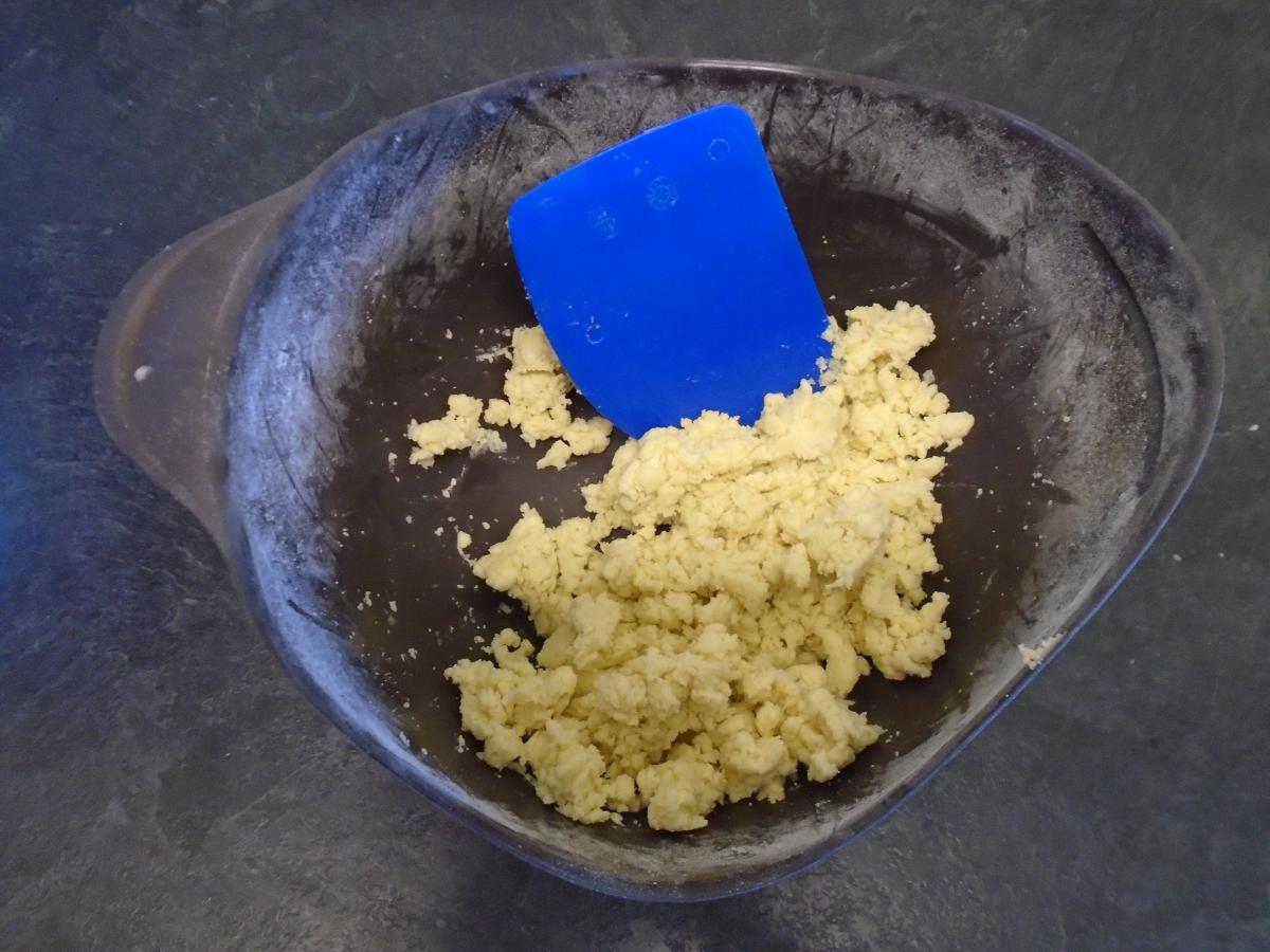 Don't be tempted to add more water, just keep going with the cutting motion and eventually the dough will start to bind