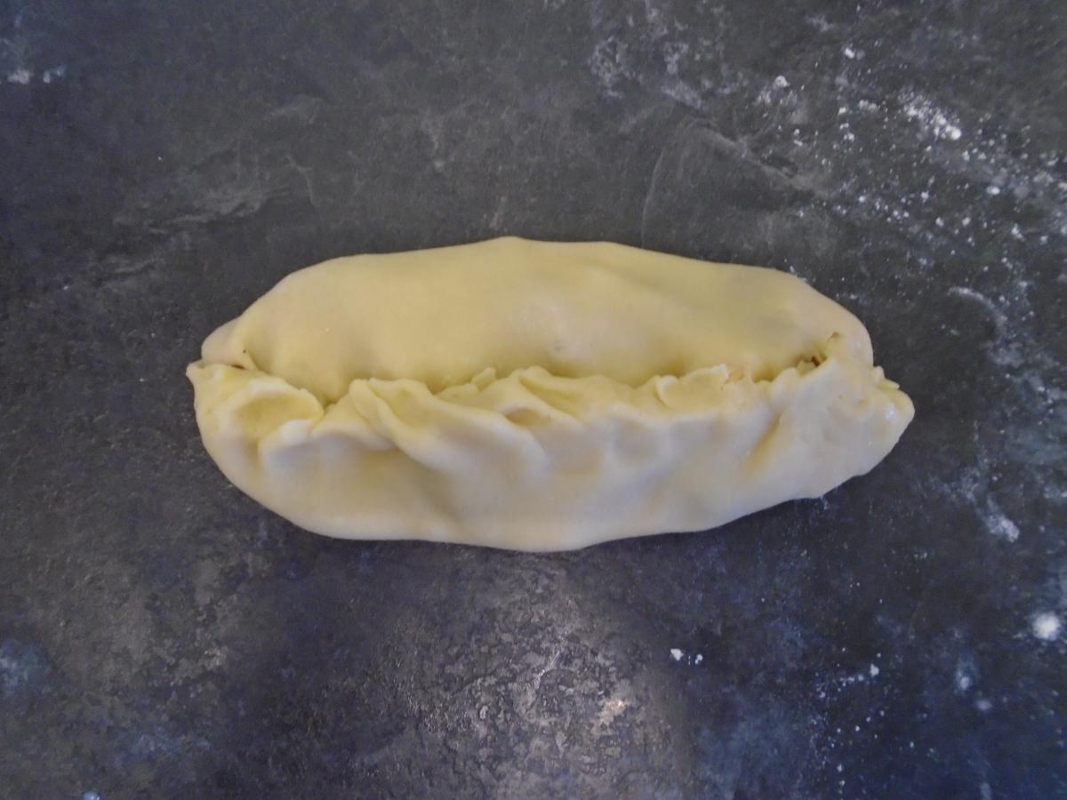 Fold the edges over & pinch firmly so it's sealed – or crimp if you know how, but it doesn't need to be neat!