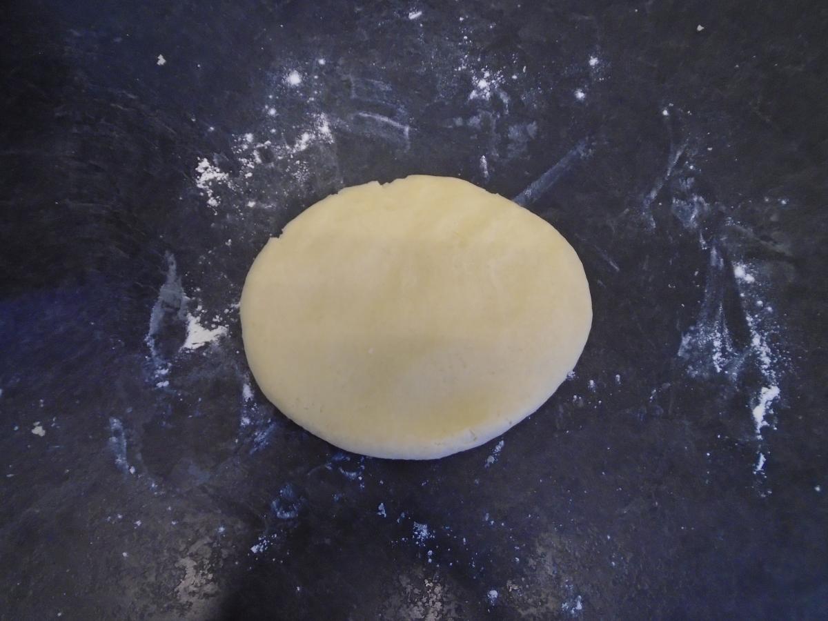 Lay the dough out onto a well-floured surface and knead briefly, so that it forms one whole piece
