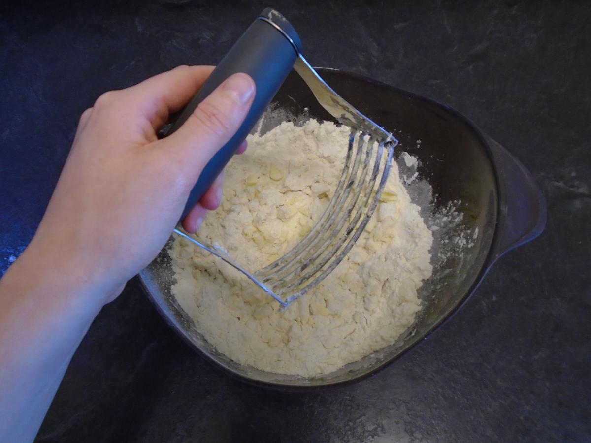 Use a pastry blender to chop the butter finely into the flour, or rub it between your fingertips (just ensure you have cool hands as the butter needs to stay cold)