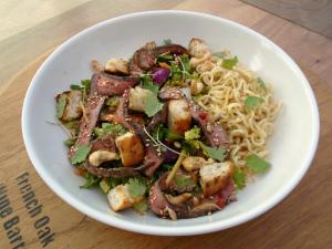Plate up the noodles, salad, beef & croutons before drizzling all over with the dressing