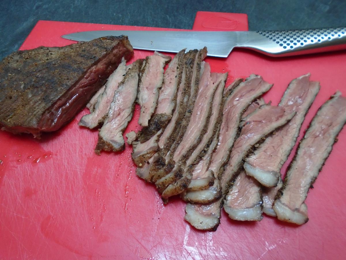 When done, transfer the steaks to a board to rest before slicing into very thin strips
