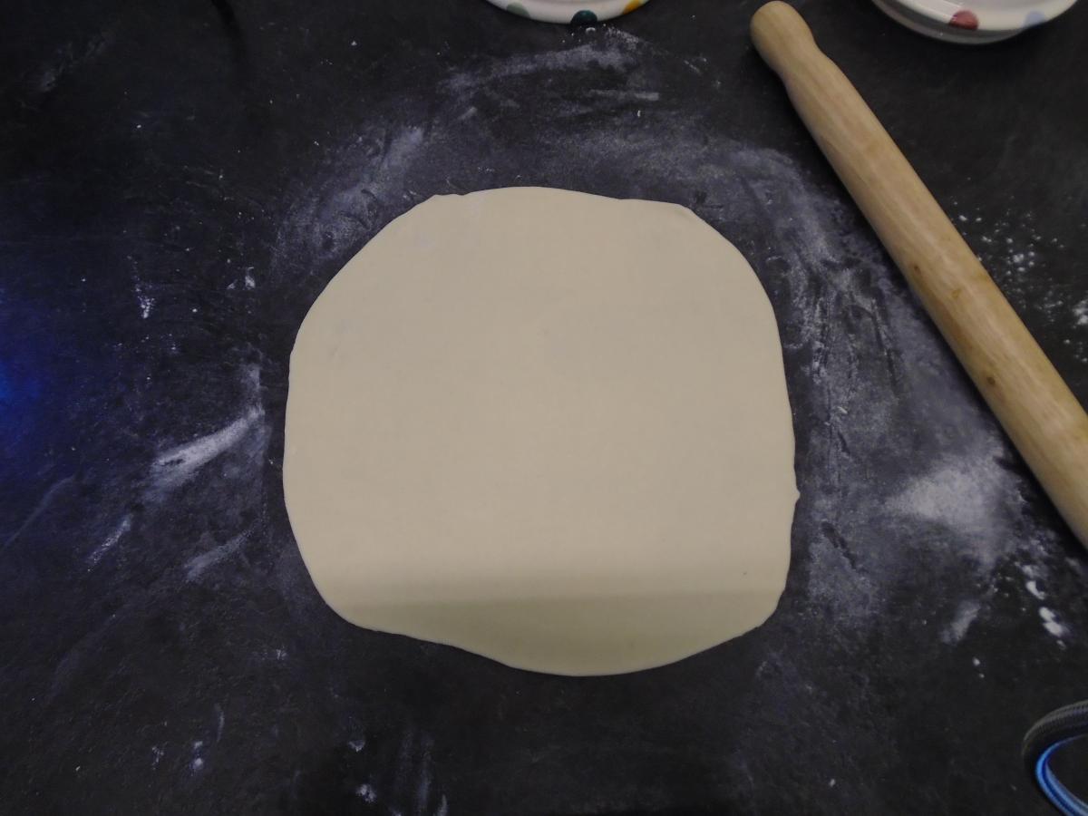 Roll out until it's a rough circle about 8-9 inches in diameter